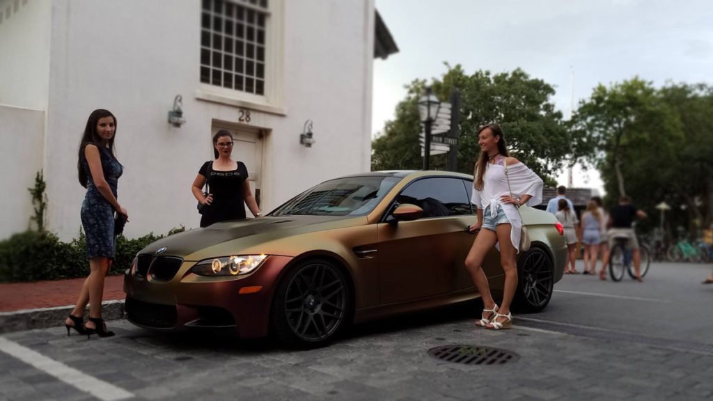 Vehicle wrap Destin experts installiVinyl Wrap Destin Professionals Installing Satin Rising Sun Wrapng colorshift vinyl on BMW M3