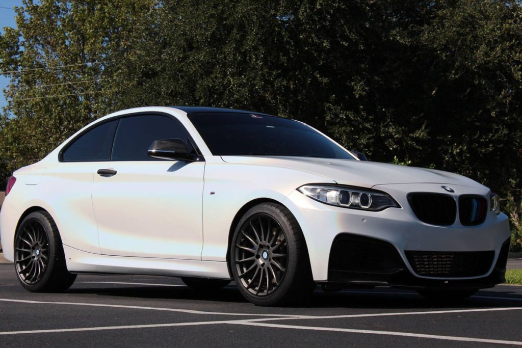 Gloss black mirror and trim accentGloss Black Accents on Psychedelic BMW M235 Wraps on BMW M235 with satin psychedelic base wrap.