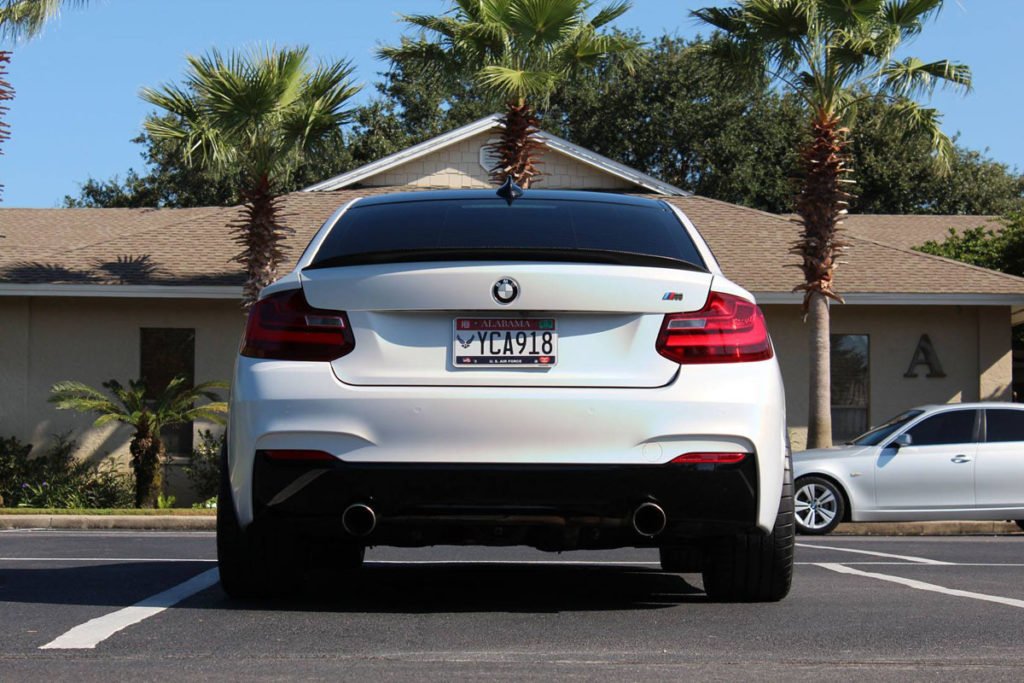 BMW M235 fully wrapped in satinBMW M235 Full Vehicle Wrap – Satin White Psychedelic by 10-4 Wraps white psychedelic vinyl with gloss black details.